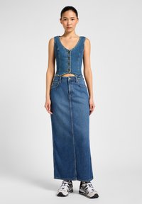 Denim co-ord featuring a sleeveless top with buttons and a long skirt. Blue color, smooth texture, and straight silhouette with side slits.
