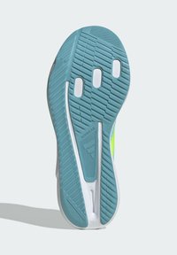 Shoe sole with a textured blue rubber surface, featuring white grooves and accents, and a logo marked 'ADIWEAR.'