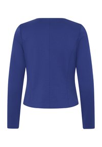 Blazer da donna aderente a maniche lunghe blu, mostrato da dietro con dettagli di cuciture e un orlo leggermente corto.