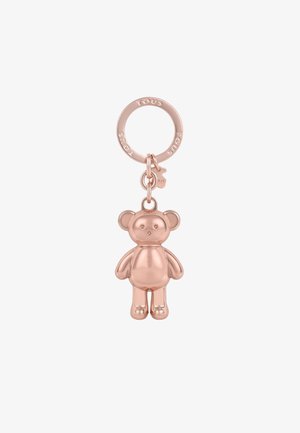 Un pendentif ours en peluche en or rose avec des formes lisses et arrondies, attaché à un porte-clés circulaire, mettant en avant une texture métallique brillante.