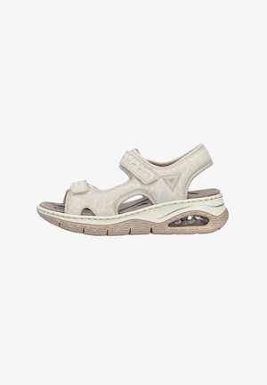 Beige Sandalen mit offenem Zehenbereich, verstellbaren Klettverschlüssen, strukturierter Oberseite und gepolsterter Sohle mit sichtbarem Luftpolster für zusätzlichen Komfort.