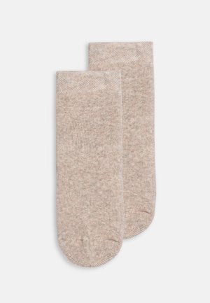 Calze lunghe fino al ginocchio in un leggero color beige, realizzate in un morbido materiale testurizzato con un sottile motivo melangiato e punta e tallone rinforzati.