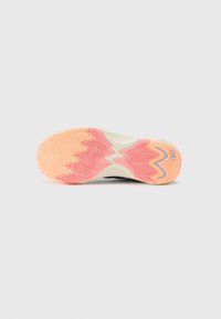 Sneakersål med et bølget mønster i orange og pink, der overgang til en cremefarvet bund. Tekstureret overflade for godt greb og trækkraft.