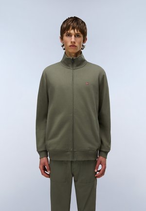 Olive green zip-up sweatshirt with a high collar, ribbed cuffs, and waistband, featuring a small logo on the left chest. Smooth fabric texture.