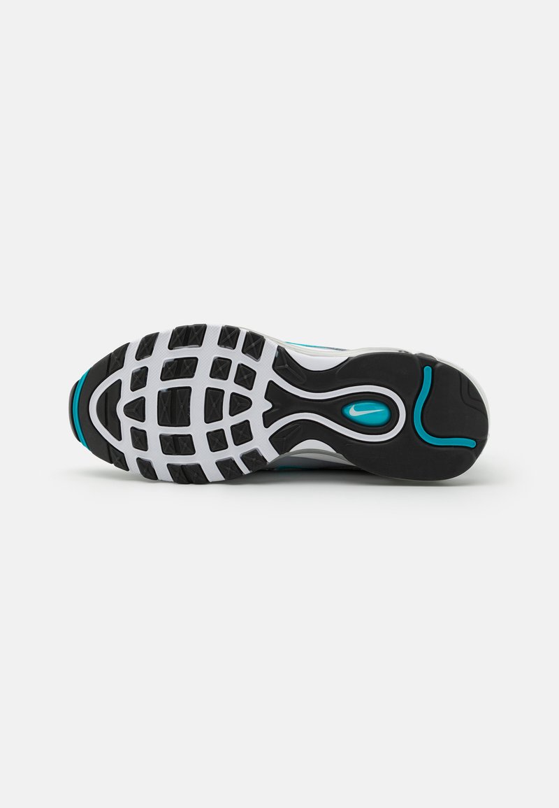 Sole di scarpa sportiva in bianco e nero con un motivo di battistrada testurizzato e accenti in teal. Presenta un design a onde e un supporto per l'arco plantare prominente.
