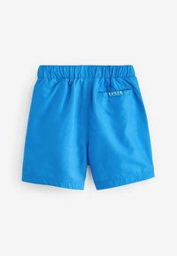 Pantaloni da nuoto blu realizzati in materiale leggero con vita elasticizzata. Presentano una tasca sul retro con dettaglio del logo bianco "B.A.K.E.R.".
