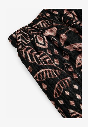 Tessuto nero con una superficie texturizzata, caratterizzato da un motivo a foglia rosa e beige. Vita elasticizzata con cuciture decorative.