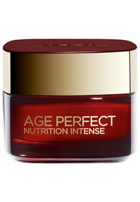 Pot en verre rouge avec un couvercle doré. L'étiquette indique "AGE PERFECT NUTRITION INTENSE" en texte doré, mettant en avant le nom du produit. Finition lisse et polie.