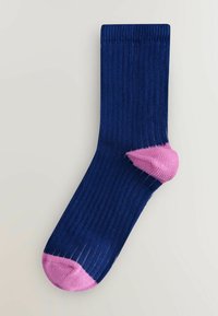 Navy ribbed sock with a pink toe and heel accents. Features a soft texture and a classic shape, suitable for everyday wear.