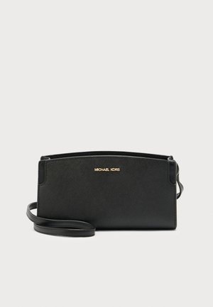 Black leather crossbody bag with a textured finish, featuring a gold logo accent and a removable strap for versatility.