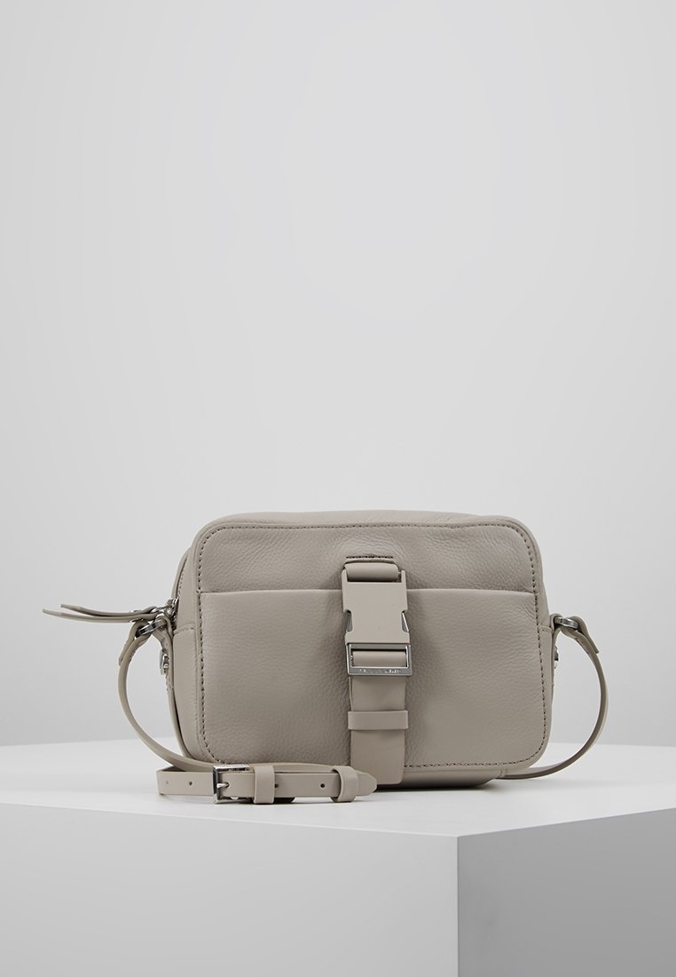 Kompaktowa szara skórzana torba na biodro o teksturowanej powierzchni, z regulowanym paskiem i wyraźną srebrną klamrą z przodu.