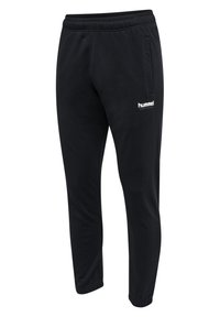 Schwarze Jogginghose aus weichem Material, mit schmal zulaufendem Schnitt, elastischem Bund, Seitentaschen und einem kleinen weißen Logo auf der Vorderseite.