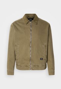 Olive green zip-up jacket with corduroy collar, two front slit pockets, and a small rectangular black brand patch near the hem.
