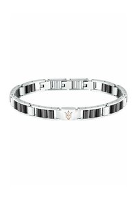 Silversmycke med svarta accenter, länkdesign och ett roséguld emblem. Slät textur med polerade och matta ytor.