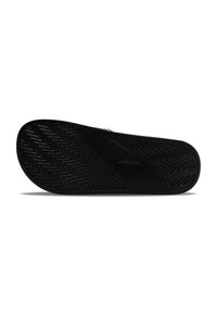 Black shoe sole featuring a wavy herringbone pattern, made of durable rubber with a textured grip surface and a central circular accent.