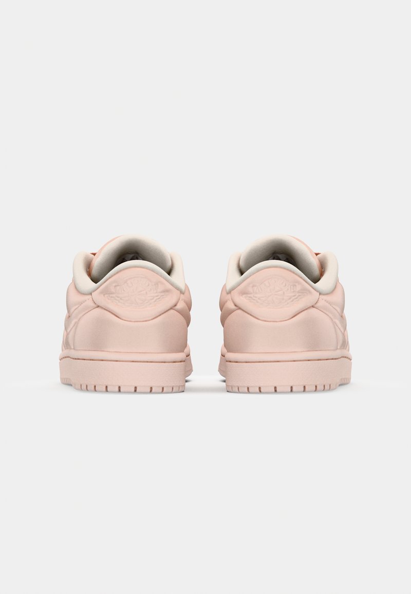 Zapatillas de cuero rosa con una textura suave, bordes redondeados, collar acolchado y un logo sutil en el talón. Suela de goma con dibujo de tracción.
