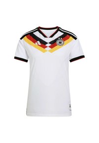 Maillot de football blanc avec un motif en chevron noir et coloré (noir, rouge, jaune) sur la poitrine ; comporte un col en V et un logo sur le côté gauche.