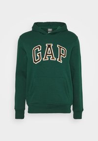 Felpa verde con cappuccio realizzata in cotone, dotata di tasca frontale. Presenta un grande logo "GAP" in lettere bianche e gialle contornate.