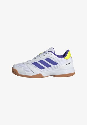 Weißer Sportschuh mit lila Streifen, gelber Fersenschlaufe, Gummisohle und "LIGRA"-Logo an der Seite.