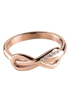 Bague en métal plaqué or rose avec un motif de boucle d'infini, ornée de cinq petits cristaux clairs d'un côté.