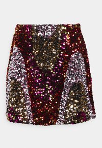 Minijupe en sequins arborant un motif rouge, doré, violet et argenté, avec une coupe ajustée et une surface texturée.