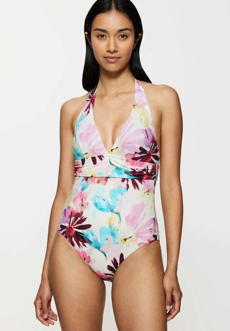 Traje de baño de una pieza con estampado floral, que presenta un cuello halter, un escote pronunciado y una mezcla de tonos rosa, azul y púrpura sobre un fondo crema.