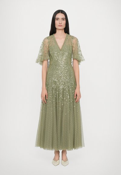 Long olive green dress with short, ruffled sleeves and a deep V-neck. Covered in sequins and layered tulle for added texture and volume.