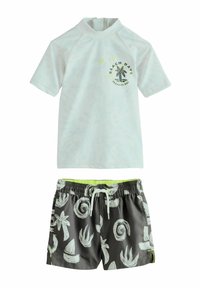 Rash guard a maniche corte di colore azzurro chiaro con grafica "BEACH DAYS", abbinato a shorts da bagno antracite con motivi tropicali bianchi e accenti neon.