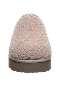 Beige, textured slip-on shoe made of soft material with a rounded toe and a thick, lightweight sole. No visible patterns or hardware.