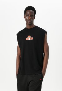 Black sleeveless t-shirt made of cotton featuring a graphic print in orange and white. Simple, relaxed fit with round neckline.