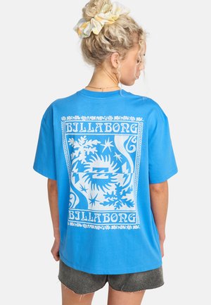 Blue cotton t-shirt with a white graphic design on the back, featuring stylized motifs and the brand name "Billabong." Short sleeves, relaxed fit.
