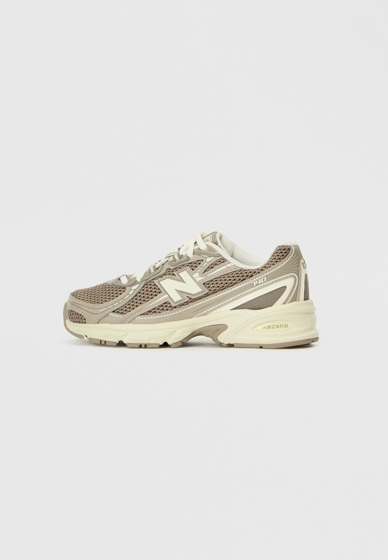 Beige athletic shoe with mesh upper and synthetic overlays, featuring a thick sole labeled "ABZORB," and white laces and accents.