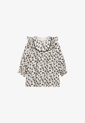 Weiße Bluse mit schwarzem Blumenmuster, gerafftem Ausschnitt und langen Ärmeln, die an den Manschetten gesammelt sind. Leichter, atmungsaktiver Stoff.