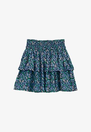 Virágmintás, réteges szoknya smockolt derékrésszel. Kék háttérrel, fehér és zöld virágmintázattal és fodros rétegekkel rendelkezik.