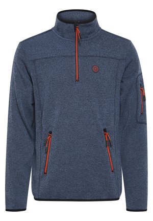 Tamsiai mėlynas vilnonis puloveris su aukštu apykakle, oranžiniais užtrauktukais, dviem šoninėmis kišenėmis ir rankovės kišenėle. Audinys tekstūruotas, o akcentai juodi.