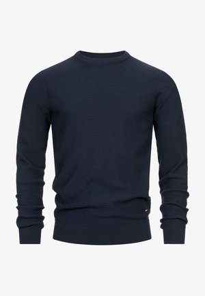 Navy knit sweater with a round neckline, textured fabric, long sleeves, and ribbed cuffs and hem. Subtle brand accent at the side.