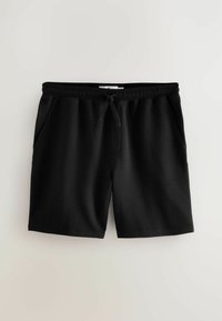 Black athletic shorts featuring a textured fabric, elastic waistband with drawstring, and side pockets. Simple design with straight cut.