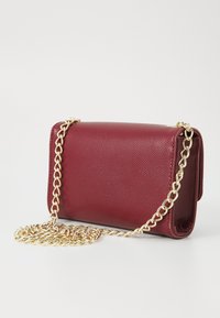 Burgundy leather handbag with a textured finish, featuring a gold chain strap and rectangular shape. Compact with a fold-over design.
