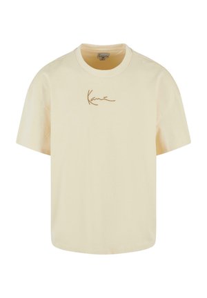 T-shirt à manches courtes de couleur crème en coton. Présente un logo signature marron sur le devant, un col rond et une coupe décontractée.