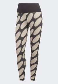 Leggings con una cinturilla negra y un diseño estampado de formas ovaladas en beige y gris oscuro. Fabricados con un tejido elástico y suave.
