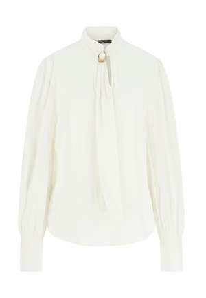 Blouse blanche à manches longues avec col montant, détail œillet doré, poignets froncés et un lien lâche suspendu au col.