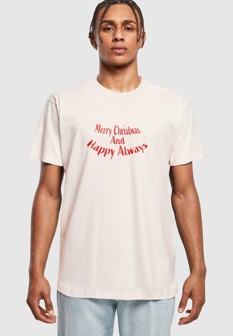 Light pink cotton t-shirt with short sleeves featuring a red graphic text that reads "Merry Christmas And Happy Always," round neckline, relaxed fit.
