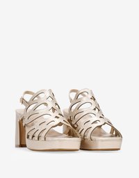 Gold high-heeled sandals with cut-out leather straps, thick block heel, and a cushioned platform for added height and comfort.