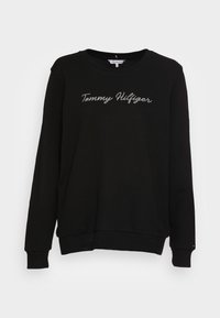 Felpa nera in cotone con collo tondo e maniche lunghe. Presenta "Tommy Hilfiger" ricamato in argento sul petto.