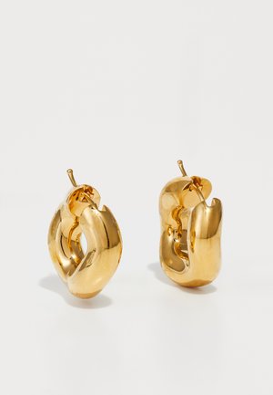 Chunky gold hoop earrings with a slightly twisted, tubular design and post back closures on a white background.