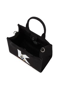 Schwarze Mini-Tasche aus Canvas mit kurzen Griffen, auf der Vorderseite mit einer Cartoon-Grafik, einer Innentasche und silbernen Ringakzenten.