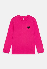 Pink long-sleeve T-shirt made of soft fabric. Features a black heart patch on the left chest. Round neckline with stitching detail.