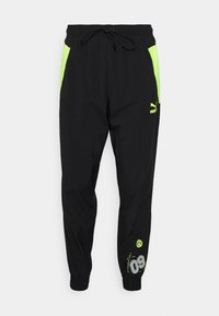 Schwarze Jogginghosen mit neongrünen Seitenpanelen, elastischem Bund mit Kordelzug und bedruckten Details, einschließlich eines Logos und der Nummer 09.