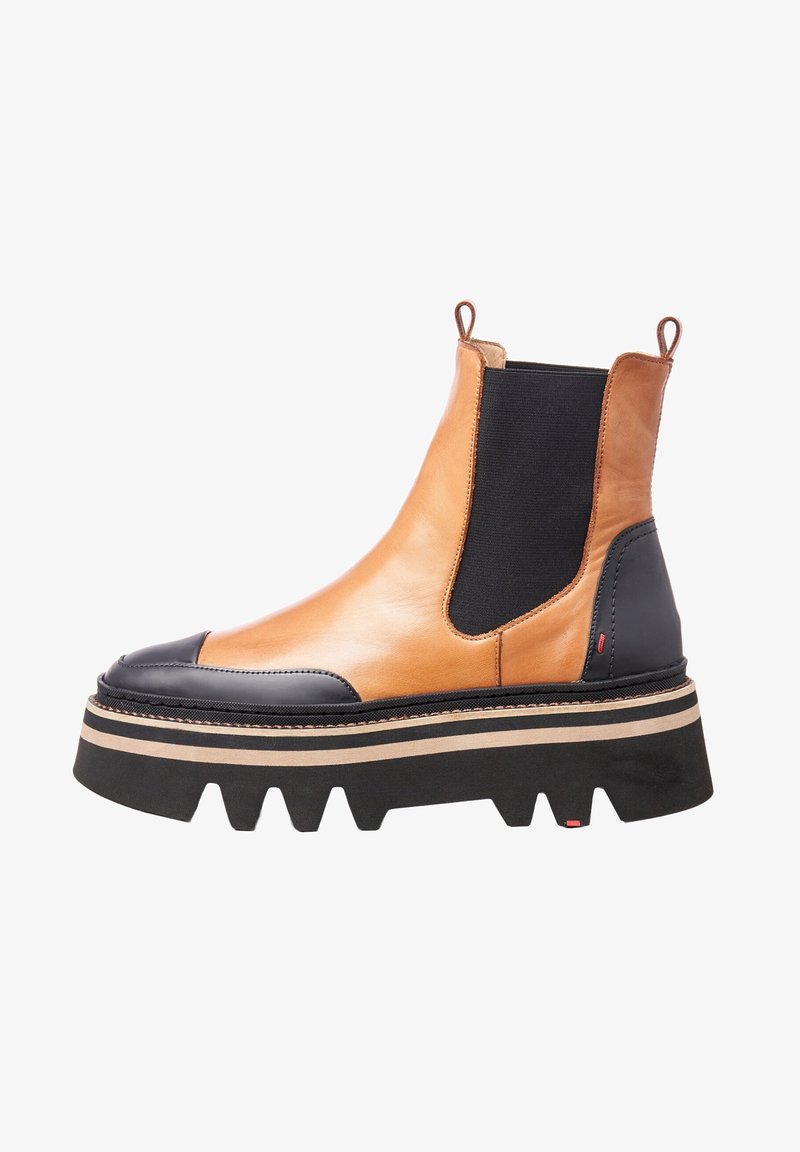 Botte Chelsea à plateforme épaisse en cuir camel et noir avec languettes de tirage, panneau latéral élastique et semelle rainurée avec rayures beige et noir.