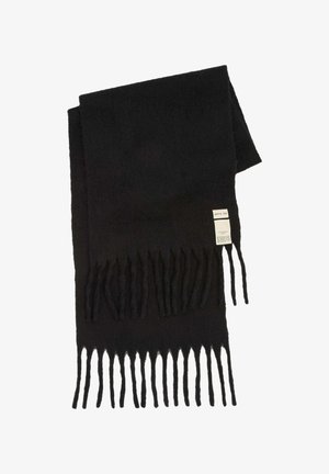 Écharpe en laine noire pliée avec des bouts frangés et une étiquette visible portant la mention "Arctic Fox" et les instructions d'entretien.